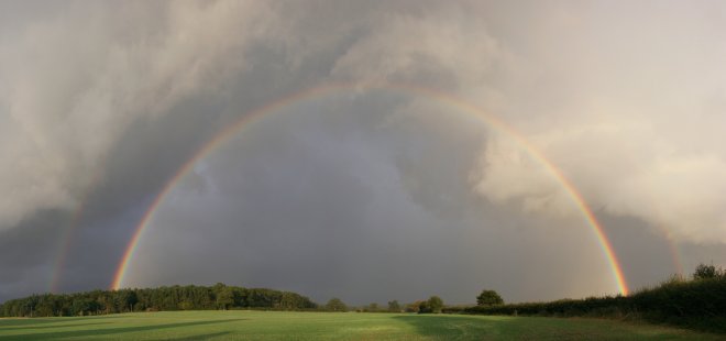 Strong full rainbow ahead of a shower